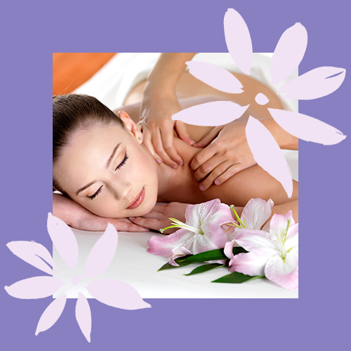 a woman relaxing with a shoulder massage next to some lilies